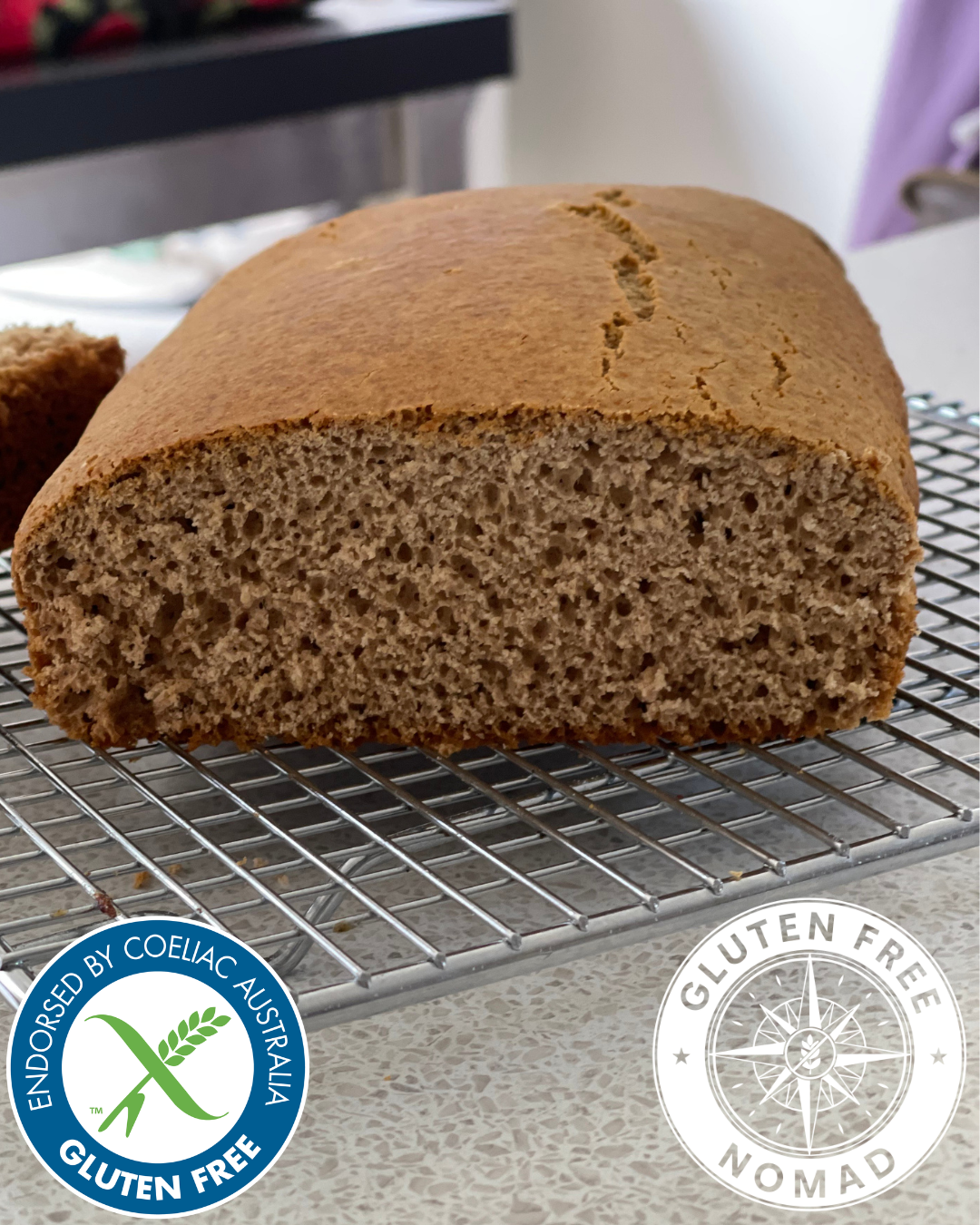 Moist gluten free honey spice loaf made with Gluten Free Nomad 1:1 All Purpose Baking Flour, sliced and served on a wooden board.