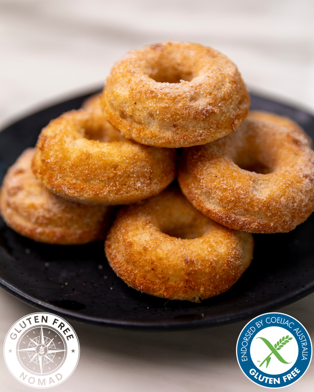 Soft and fluffy gluten free cinnamon doughnuts made with Gluten Free Nomad 1-to-1 gluten free flour